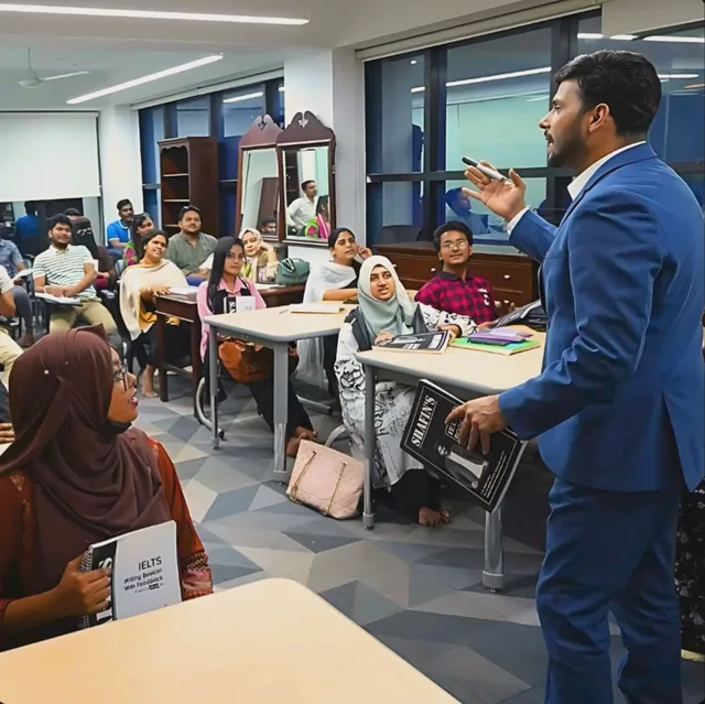 A trainer teaching a full IELTS class